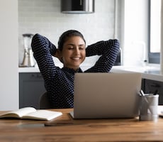 person relaxing with their laptop