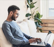 man using a laptop in a living room