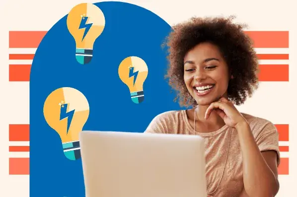 Woman looks at laptop. Lightbulbs in background.